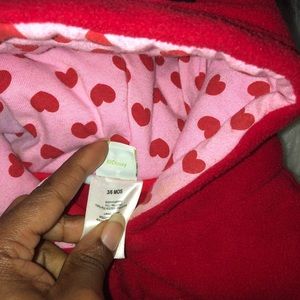 Red baby snow coat that covers the feet.